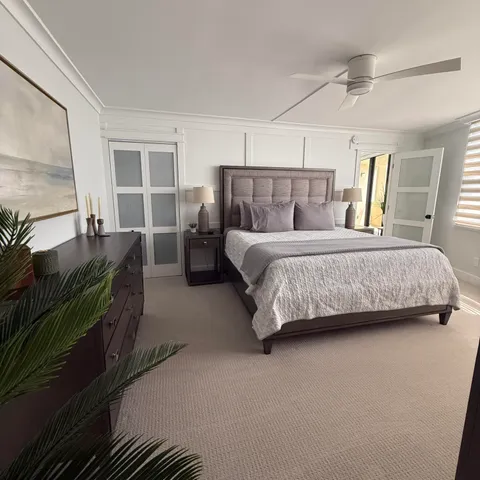 a bedroom with a bed and a dresser next to a window