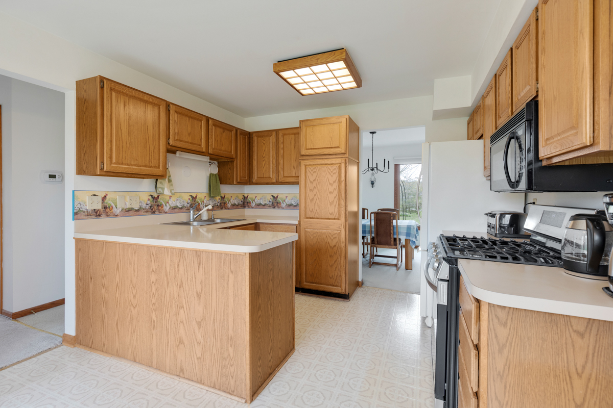 43W330 Main Street Road Elburn, IL 60119 - Photo 15 of 34 a kitchen with stainless steel appliances granite countertop a stove top oven a refrigerator a sink and dishwasher with white cabinets