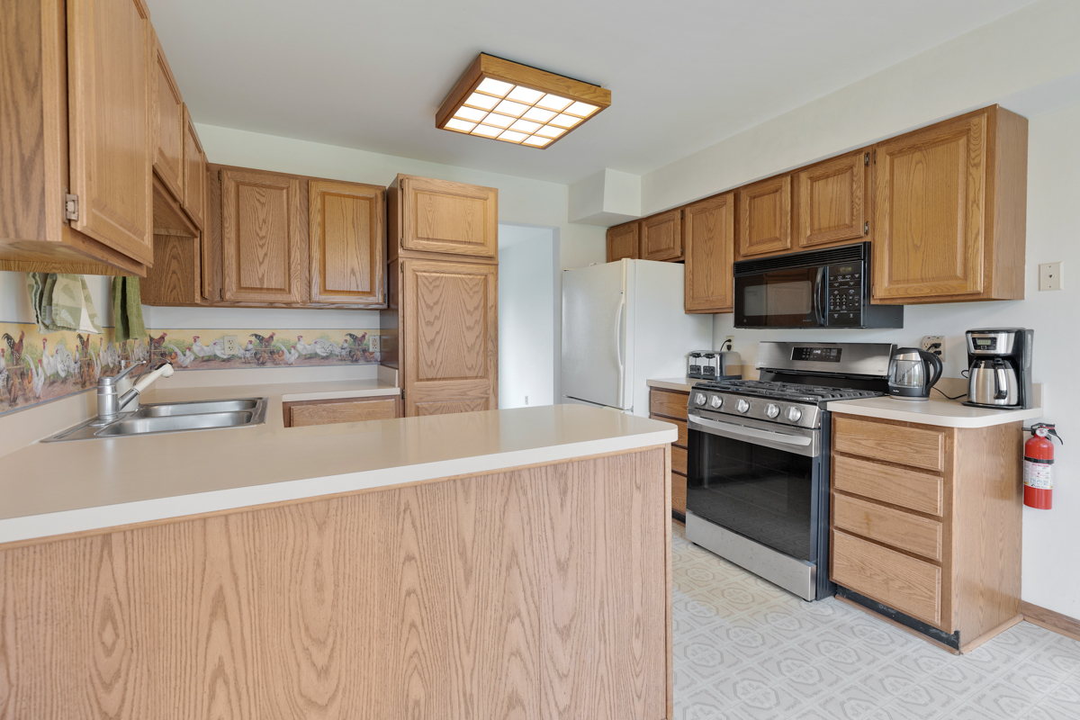 43W330 Main Street Road Elburn, IL 60119 - Photo 16 of 34 a kitchen with stainless steel appliances a stove a sink and a microwave
