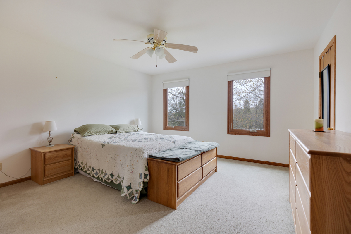 43W330 Main Street Road Elburn, IL 60119 - Photo 18 of 34 a spacious bedroom with a bed and a chandelier