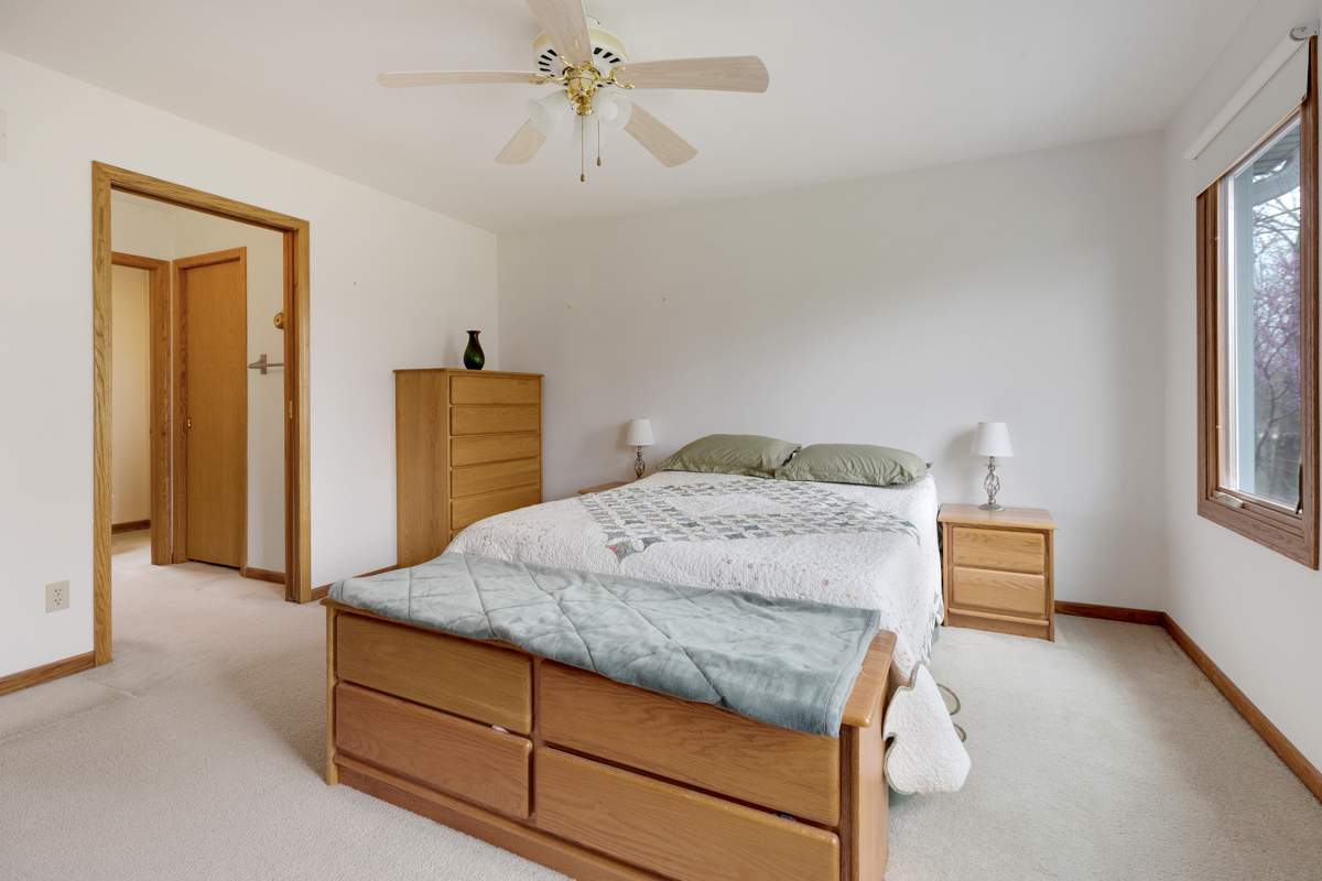 43W330 Main Street Road Elburn, IL 60119 - Photo 19 of 34 a bedroom with a bed and a chandelier
