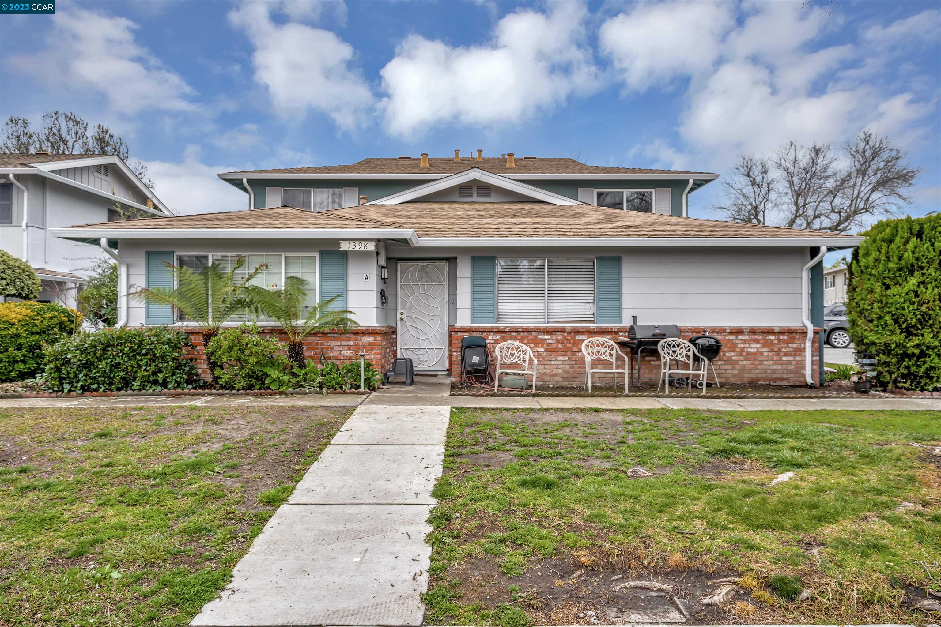 a front view of a house with a garden and plants