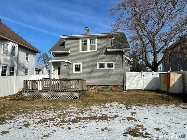 a view of a house with a wooden fence