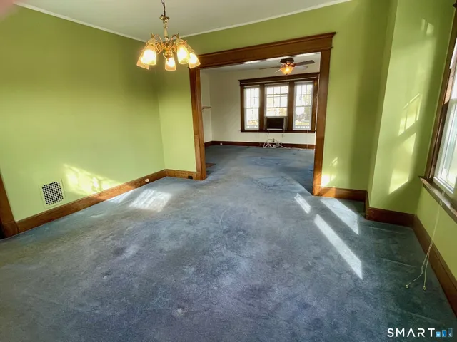 a kitchen with a refrigerator a stove and wooden floor