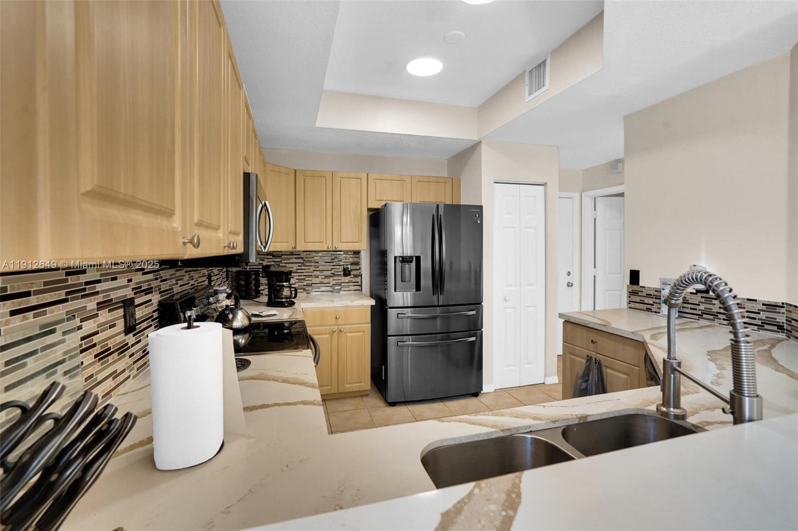 13117 Southwest 49th Court Miramar, FL 33027 - Photo 17 of 65 a kitchen with a sink appliances and cabinets