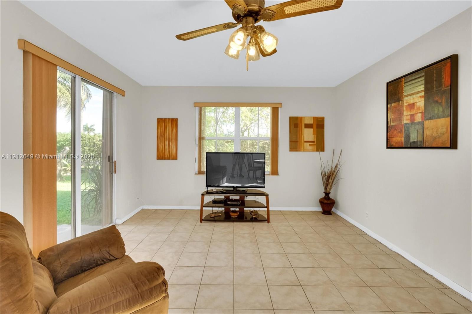 13117 Southwest 49th Court Miramar, FL 33027 - Photo 19 of 65 a living room with furniture and a flat screen tv