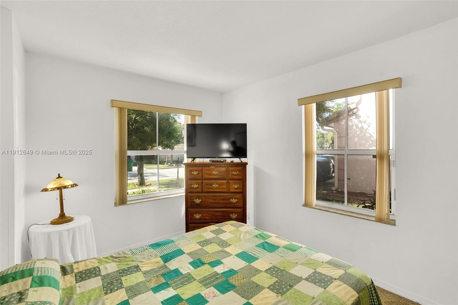 13117 Southwest 49th Court Miramar, FL 33027 - Photo 24 of 65 a bedroom with a bed and wooden floor