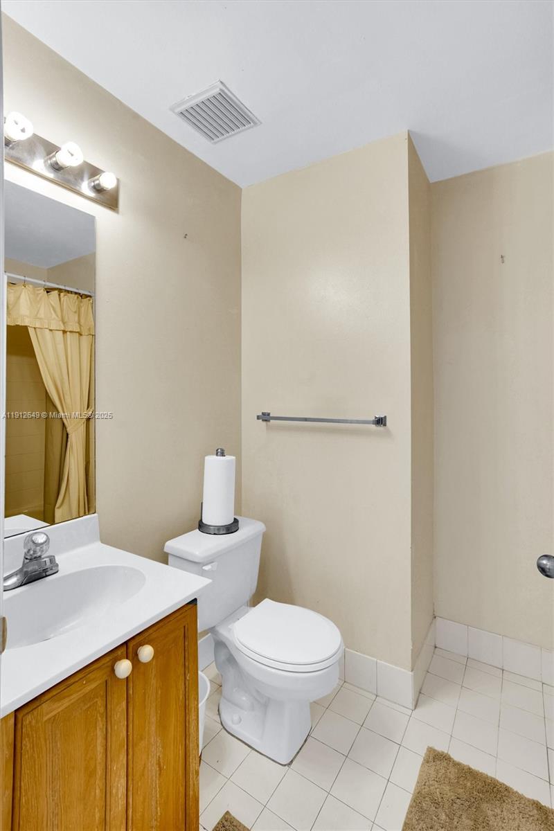 13117 Southwest 49th Court Miramar, FL 33027 - Photo 28 of 65 a bathroom with a sink a toilet and shower