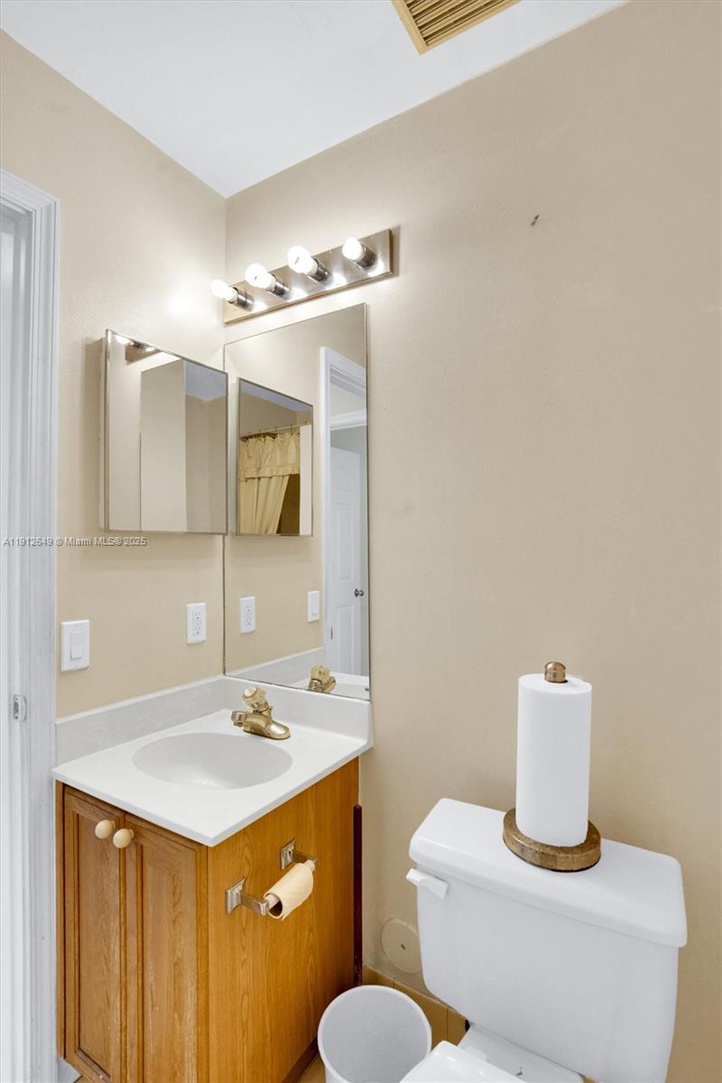 13117 Southwest 49th Court Miramar, FL 33027 - Photo 29 of 65 a bathroom with a sink toilet and mirror
