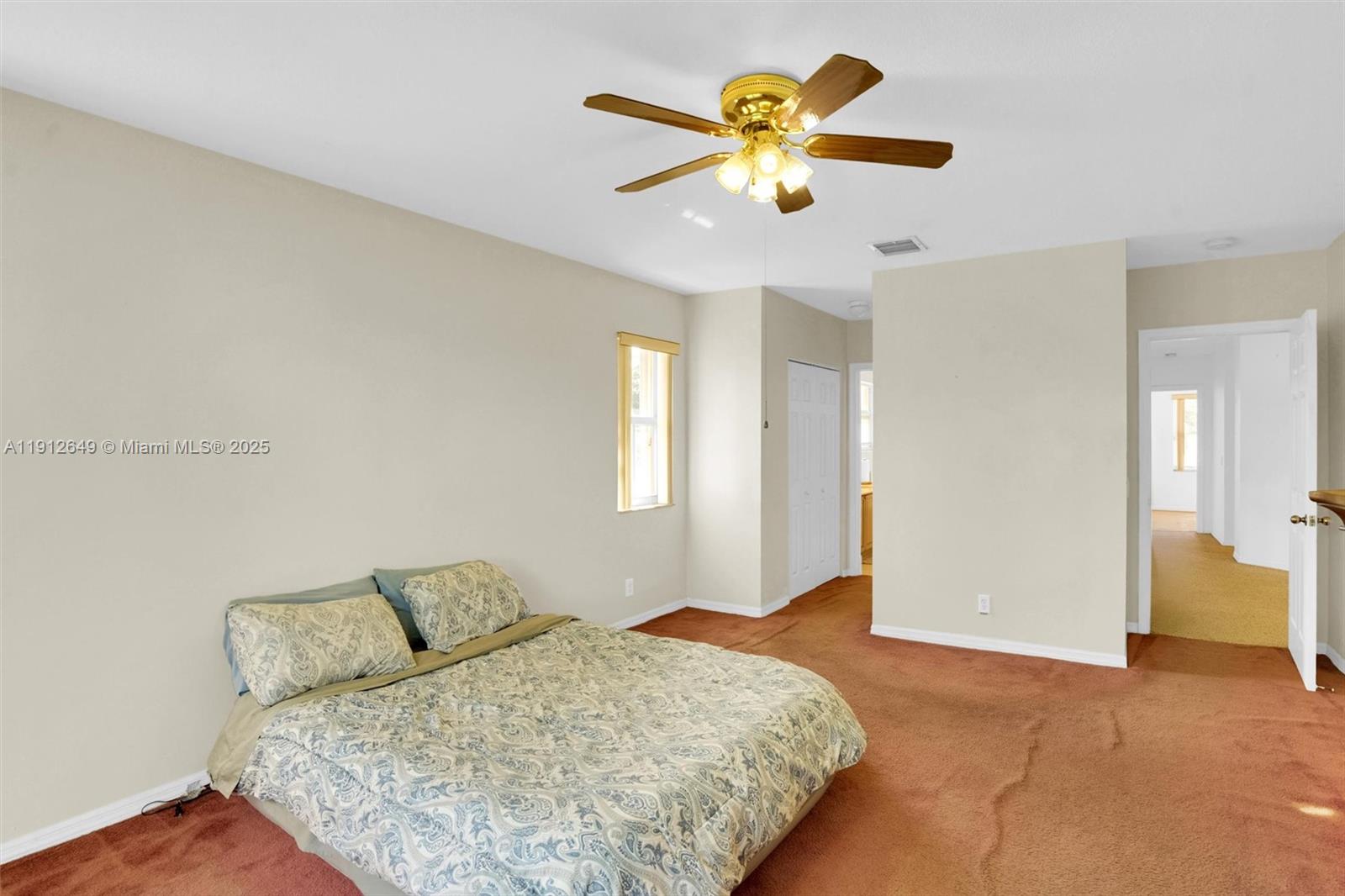 13117 Southwest 49th Court Miramar, FL 33027 - Photo 34 of 65 a bedroom with a bed and a chandelier