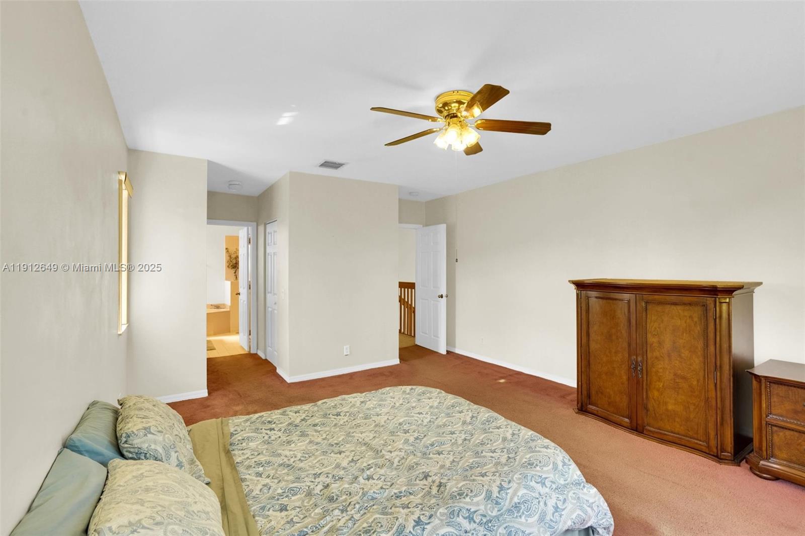 13117 Southwest 49th Court Miramar, FL 33027 - Photo 35 of 65 a bedroom with a bed and a chandelier