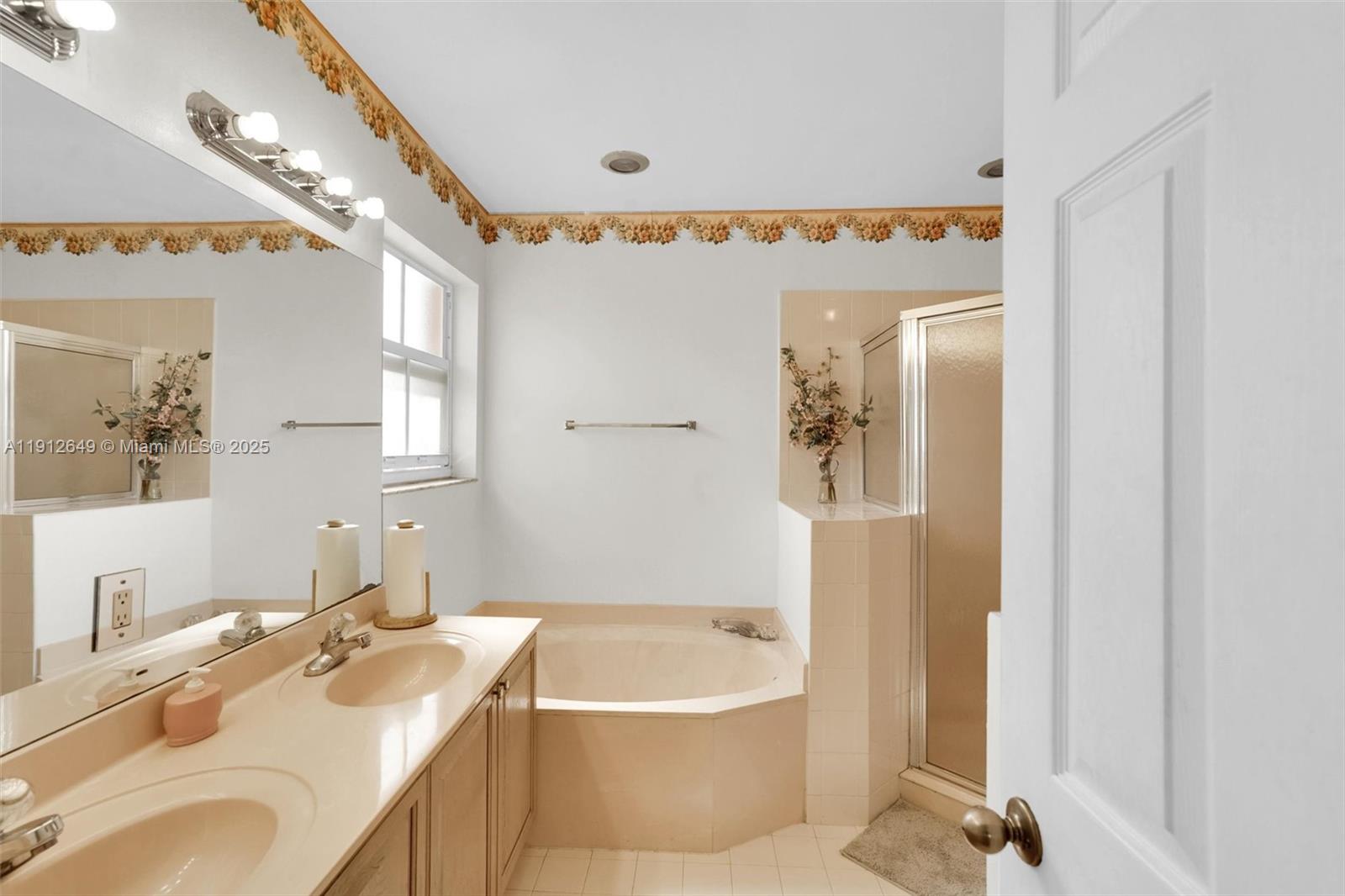 13117 Southwest 49th Court Miramar, FL 33027 - Photo 37 of 65 a bathroom with a granite countertop sink and a bathtub