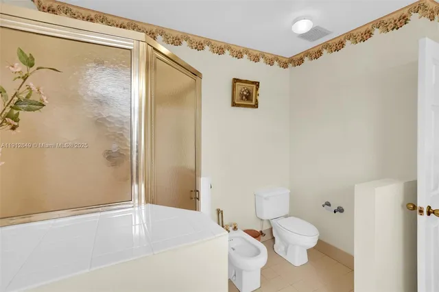 a bedroom with a bed and a ceiling fan