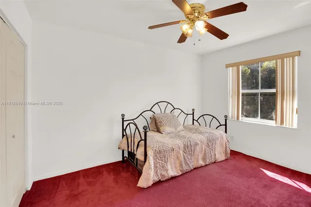 a bathroom with a sink a toilet a mirror and shower