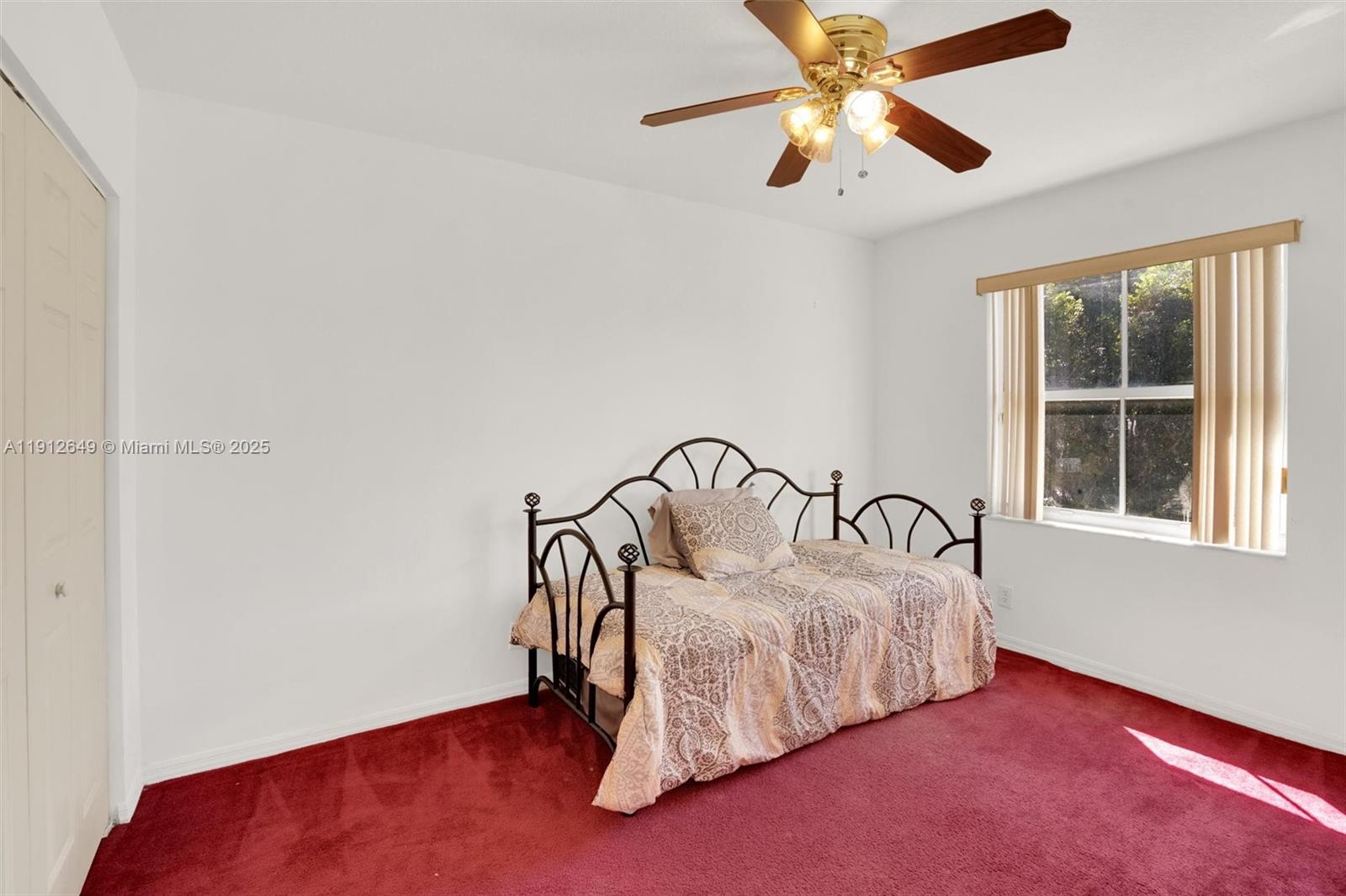 13117 Southwest 49th Court Miramar, FL 33027 - Photo 40 of 65 a bedroom with a bed and a ceiling fan