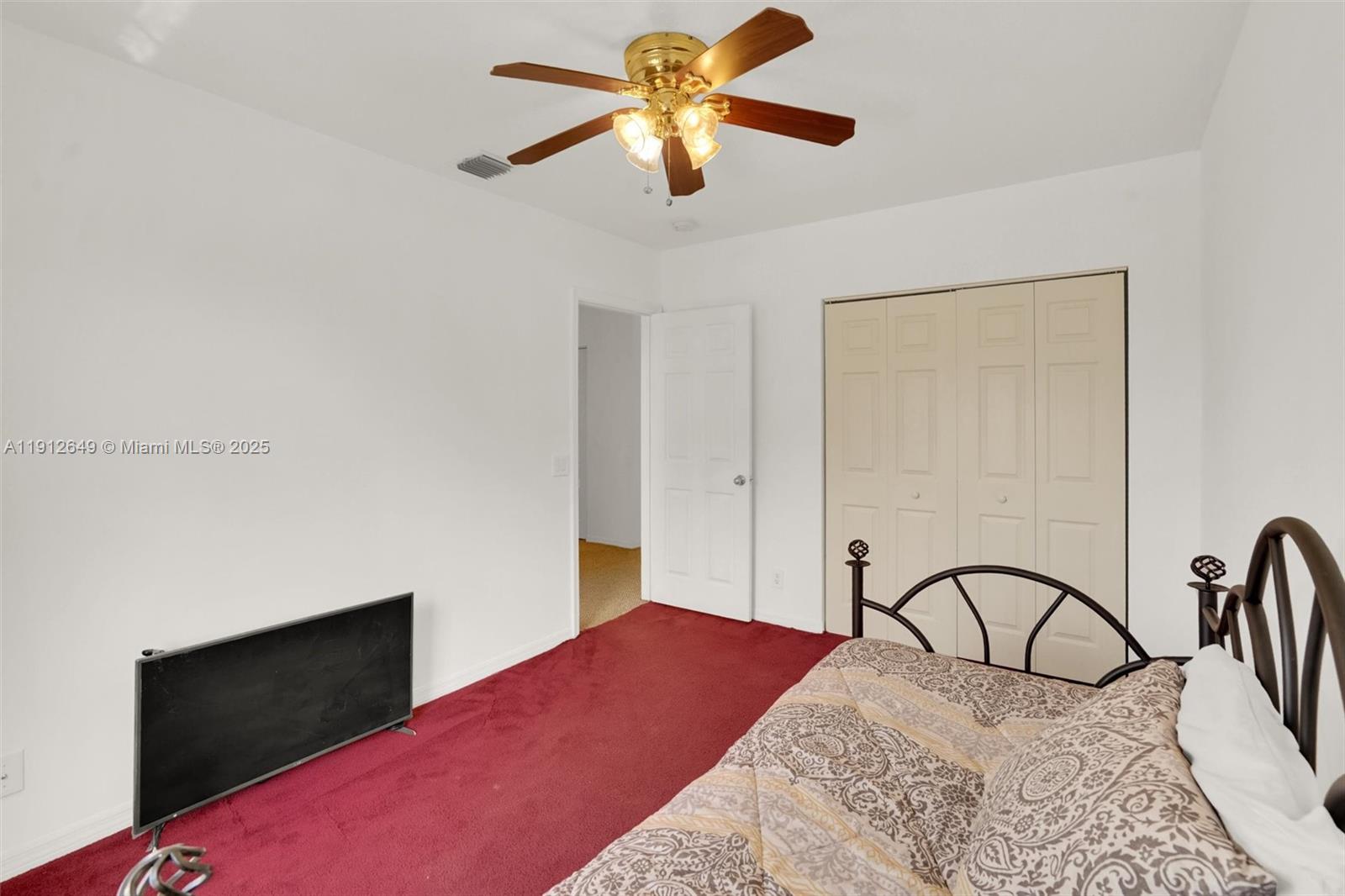 13117 Southwest 49th Court Miramar, FL 33027 - Photo 43 of 65 a bedroom with a bed and a flat screen tv