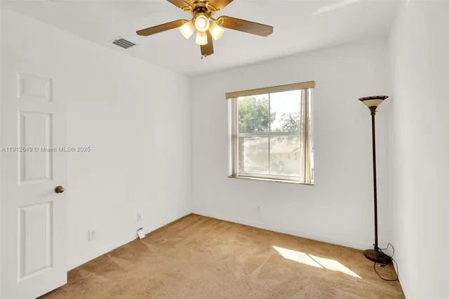 an aerial view of a house with a yard table and chairs