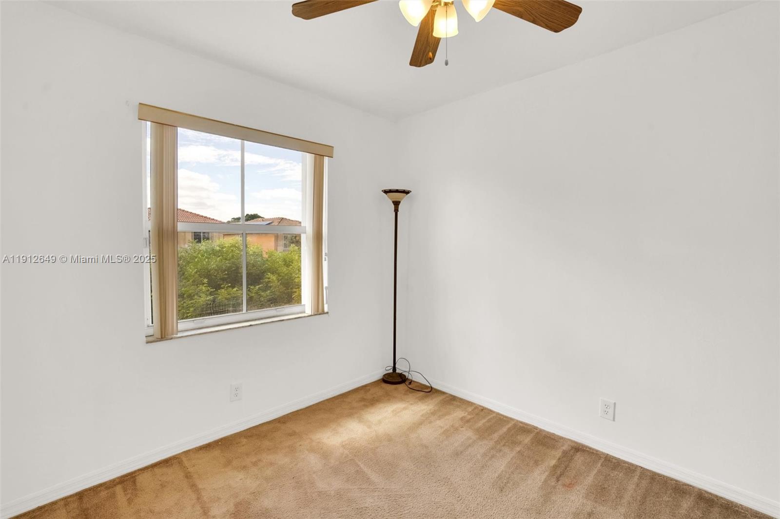 13117 Southwest 49th Court Miramar, FL 33027 - Photo 47 of 65 an empty room with a window and a ceiling fan