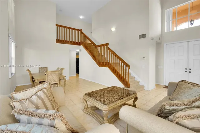 a living room with furniture and stairs