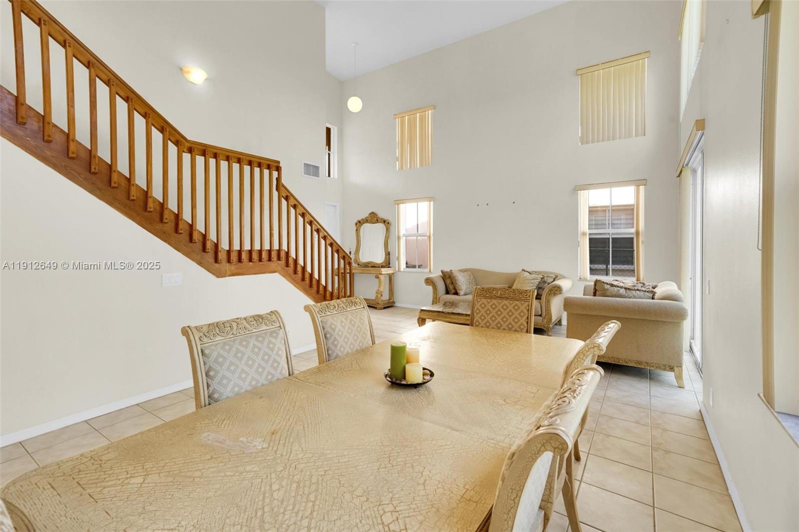 13117 Southwest 49th Court Miramar, FL 33027 - Photo 10 of 65 a living room with couches and kitchen view with wooden floor