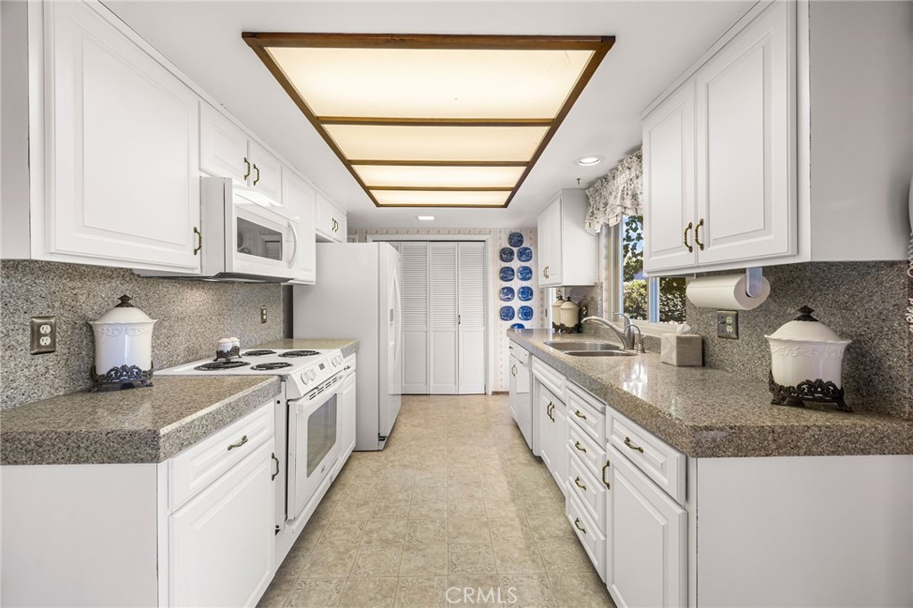 5770 Ingalls Road Paradise, CA 95969 - Photo 14 of 63 a kitchen with granite countertop a white stove top oven a white cabinet and a granite countertops with cabinets