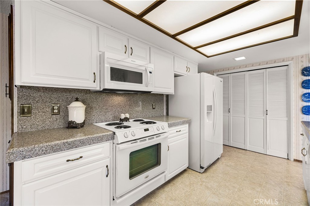 5770 Ingalls Road Paradise, CA 95969 - Photo 15 of 63 a kitchen with stainless steel appliances granite countertop white cabinets a stove a sink and dishwasher