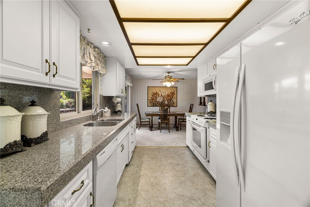 5770 Ingalls Road Paradise, CA 95969 - Photo 17 of 63 a large white kitchen with a stove a sink a refrigerator and cabinets
