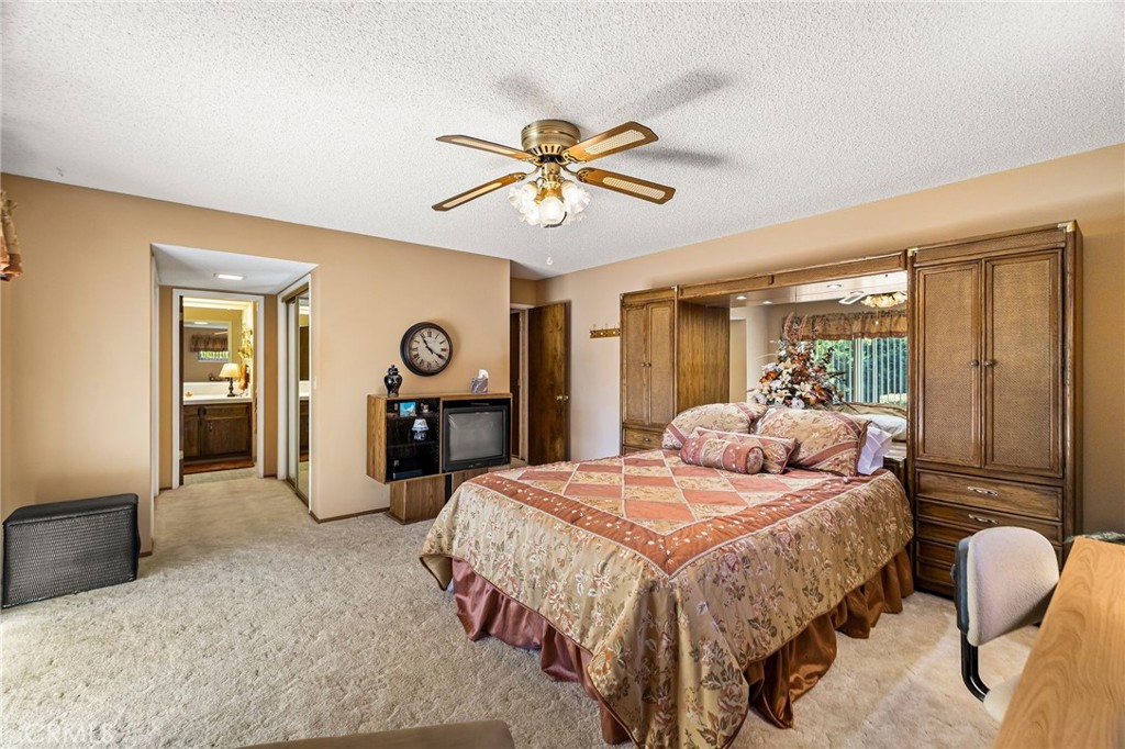 5770 Ingalls Road Paradise, CA 95969 - Photo 27 of 63 a bedroom with a bed a chandelier and dresser