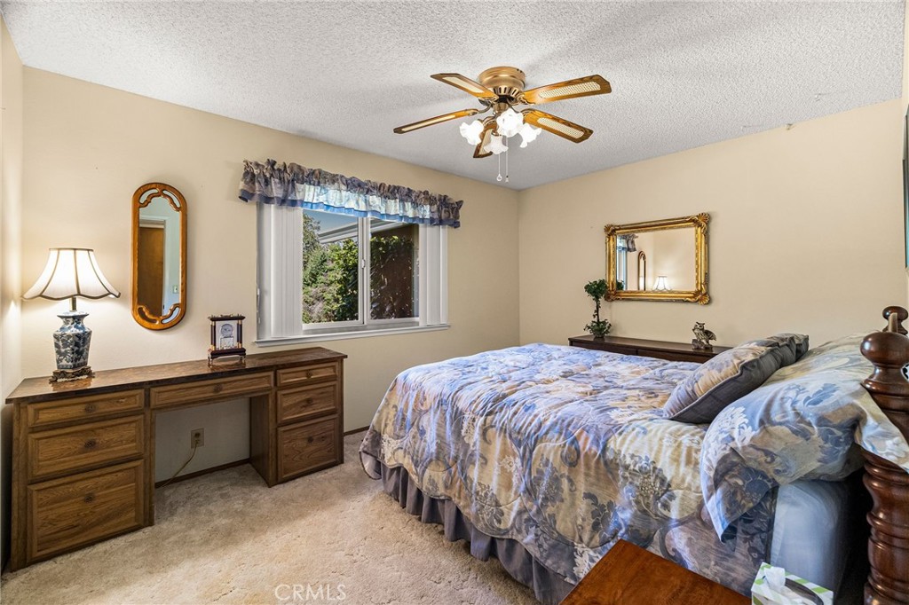 5770 Ingalls Road Paradise, CA 95969 - Photo 33 of 63 a bedroom with a large bed and a chandelier