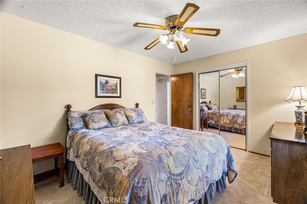 5770 Ingalls Road Paradise, CA 95969 - Photo 34 of 63 a bedroom with a bed and a chandelier