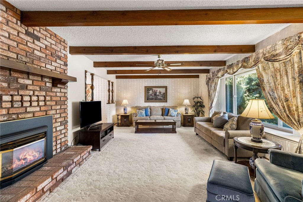5770 Ingalls Road Paradise, CA 95969 - Photo 5 of 63 a living room with furniture a fireplace and a flat screen tv
