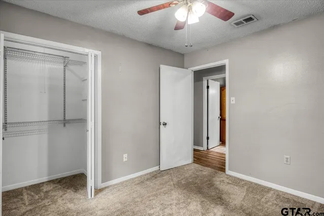 an empty room with closet area