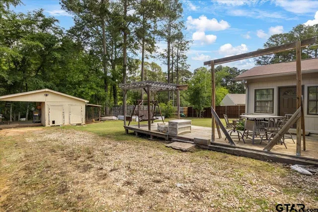 a view of a house with backyard porch and sitting area