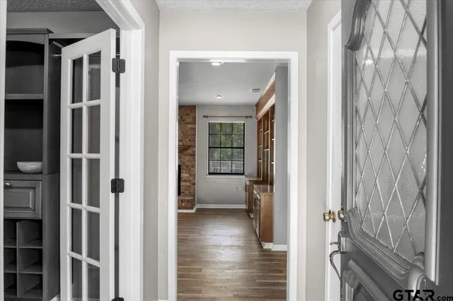 a view of a hallway with a livingroom and furniture