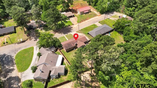 an aerial view of residential house with outdoor space and swimming pool