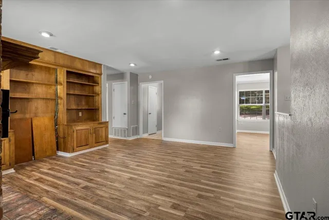 a big room with wooden floor and closet