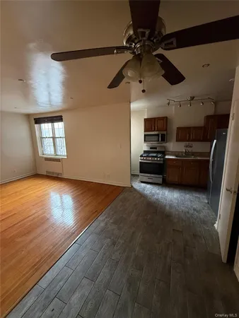 a view of a livingroom with kitchen and a fireplace