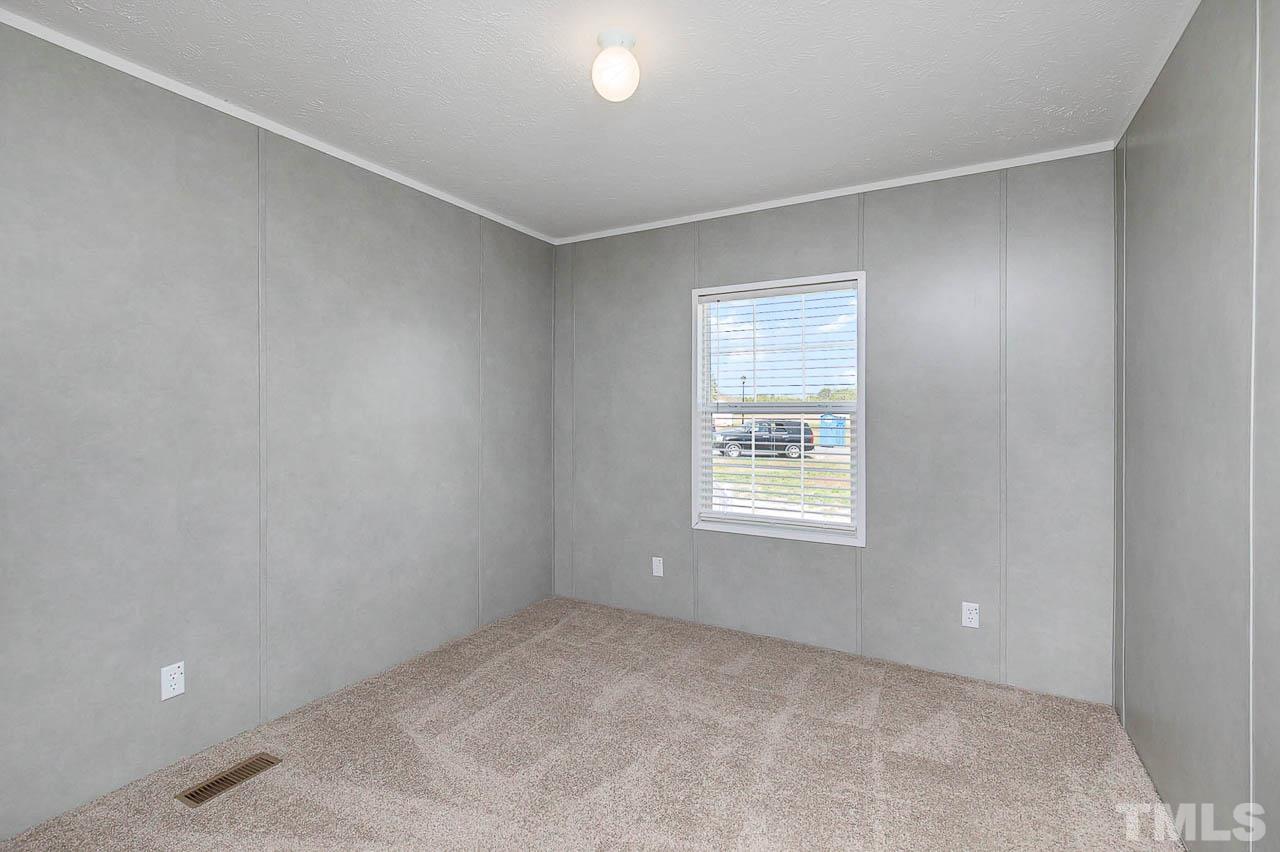 34 Ruddy Duck Lane Pine Level, NC 27576 - Photo 11 of 17 a view of an empty room with a window