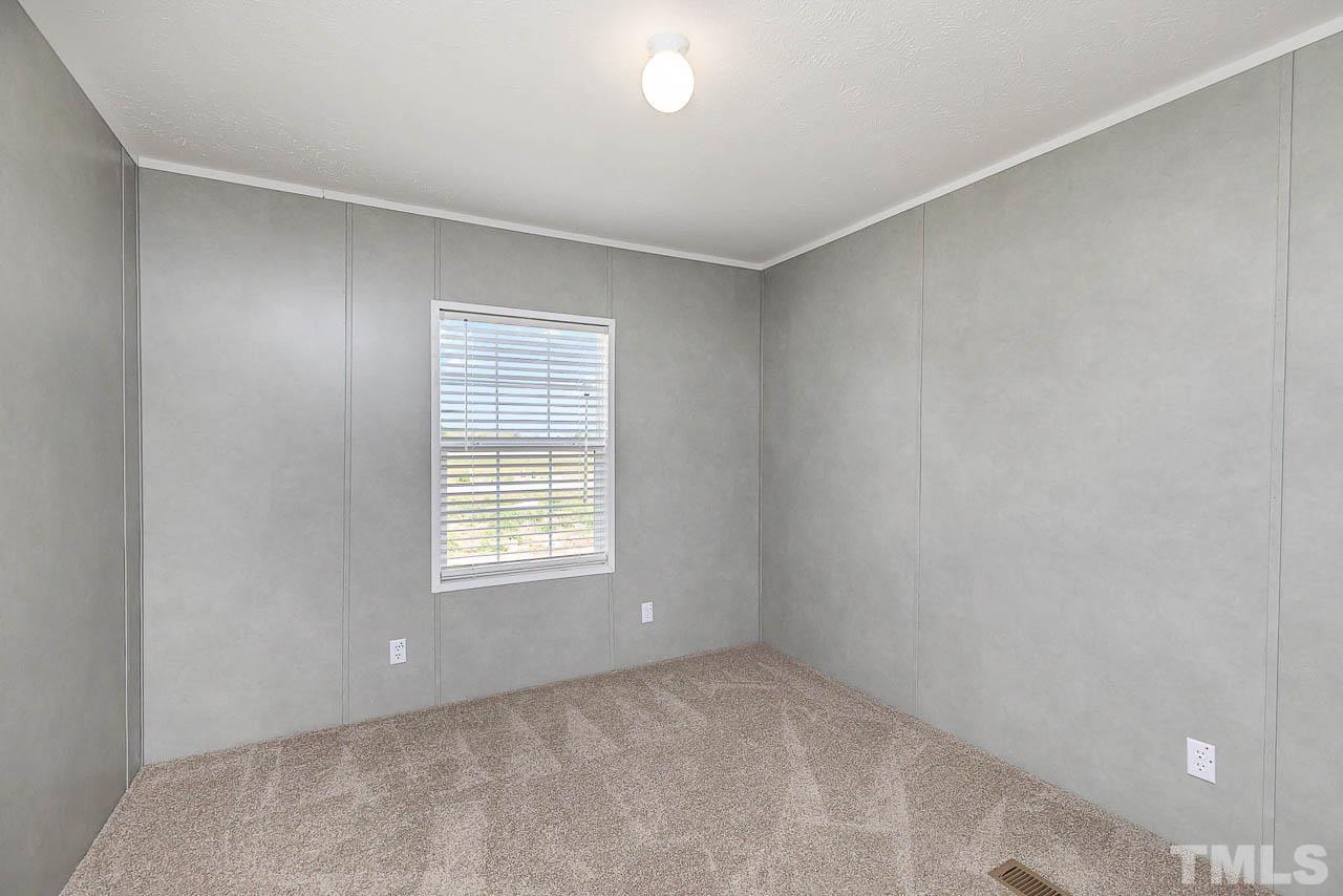34 Ruddy Duck Lane Pine Level, NC 27576 - Photo 13 of 17 a view of an empty room with a window