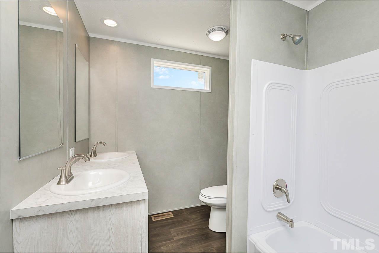 34 Ruddy Duck Lane Pine Level, NC 27576 - Photo 15 of 17 a bathroom with a sink toilet and shower