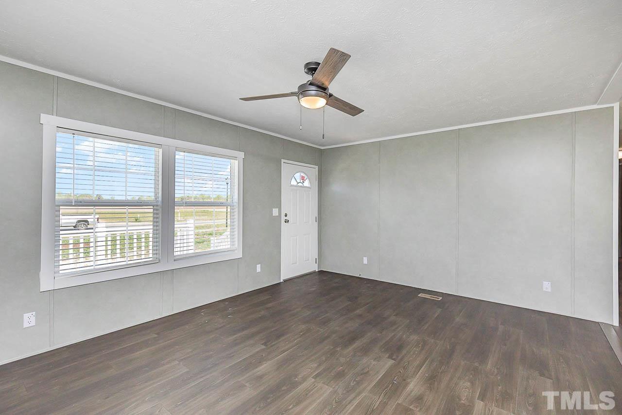 34 Ruddy Duck Lane Pine Level, NC 27576 - Photo 3 of 17 a view of an empty room with wooden floor and a window