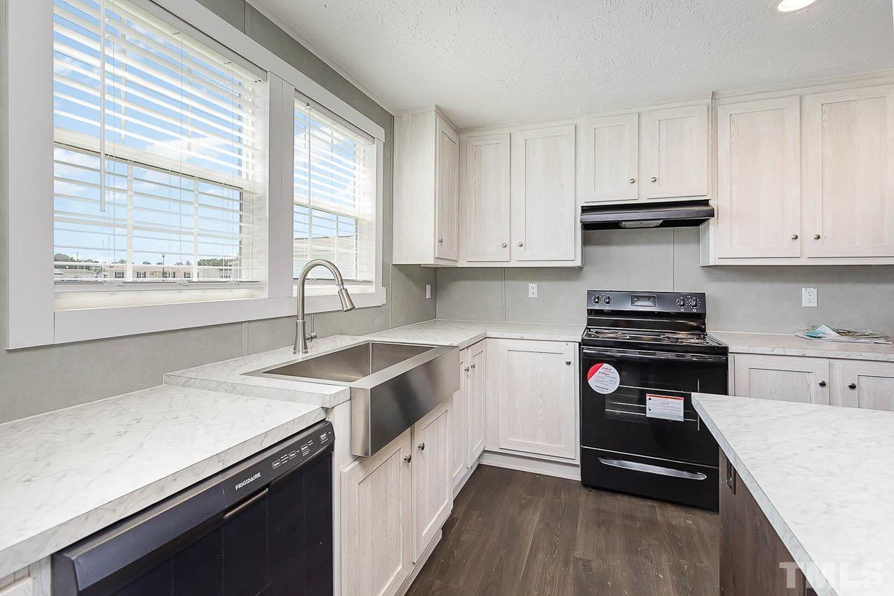 34 Ruddy Duck Lane Pine Level, NC 27576 - Photo 6 of 17 a kitchen with a sink stove top oven and cabinets