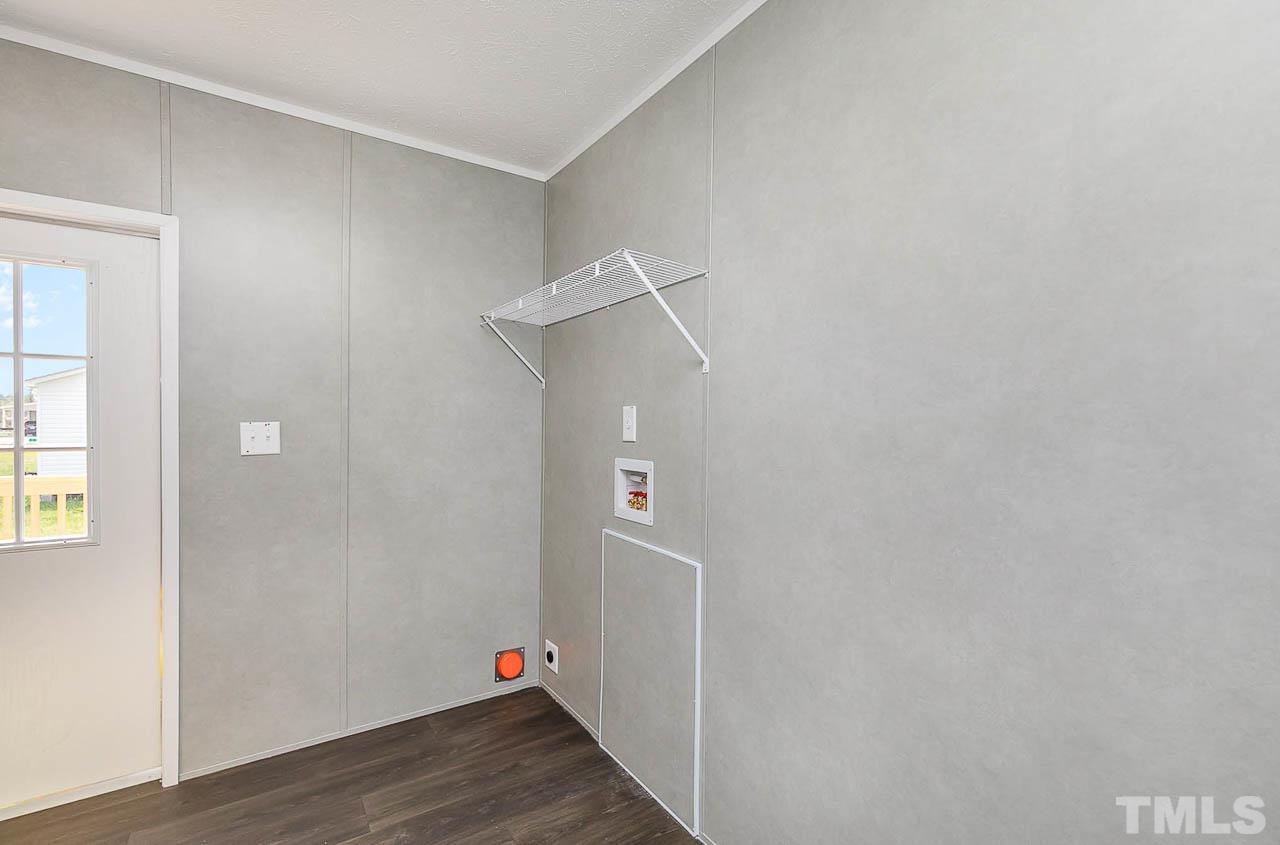 34 Ruddy Duck Lane Pine Level, NC 27576 - Photo 7 of 17 an empty room with wooden floor and windows