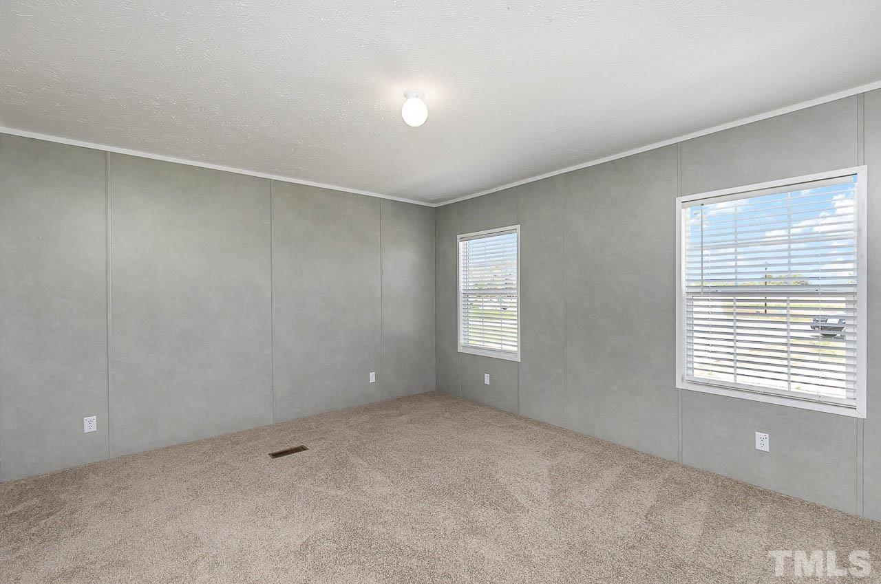 34 Ruddy Duck Lane Pine Level, NC 27576 - Photo 8 of 17 a view of an empty room with a window