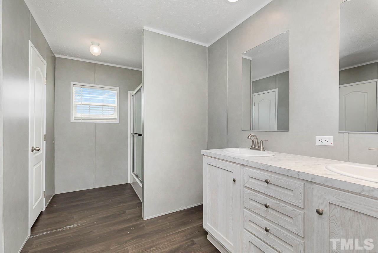 34 Ruddy Duck Lane Pine Level, NC 27576 - Photo 10 of 17 a bathroom with a double vanity sink and mirror