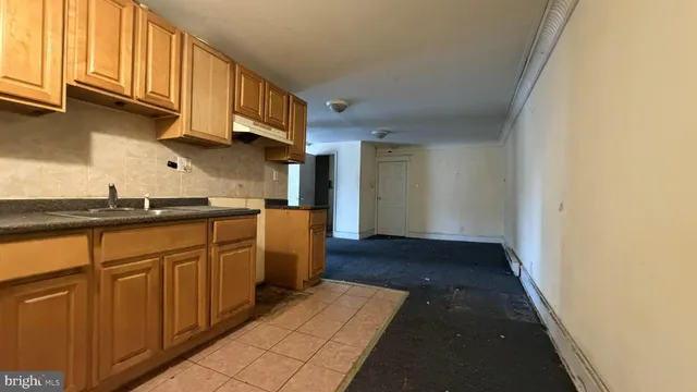 a kitchen with granite countertop cabinets stainless steel appliances a sink and a counter space