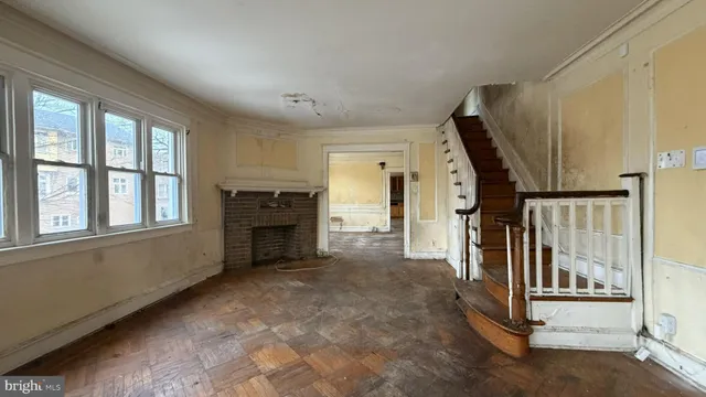 a view of a livingroom with entryway and stairs