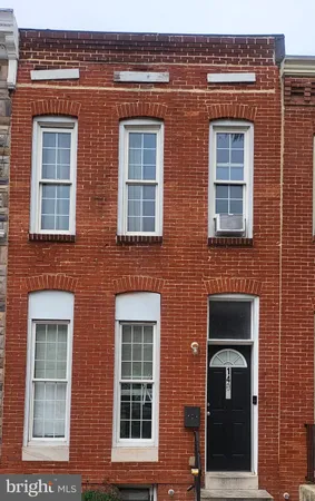 front view of a brick house with a large window