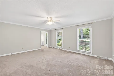 an empty room with windows and closet