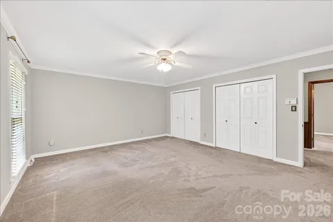 a view of a livingroom with wooden floor and a ceiling fan